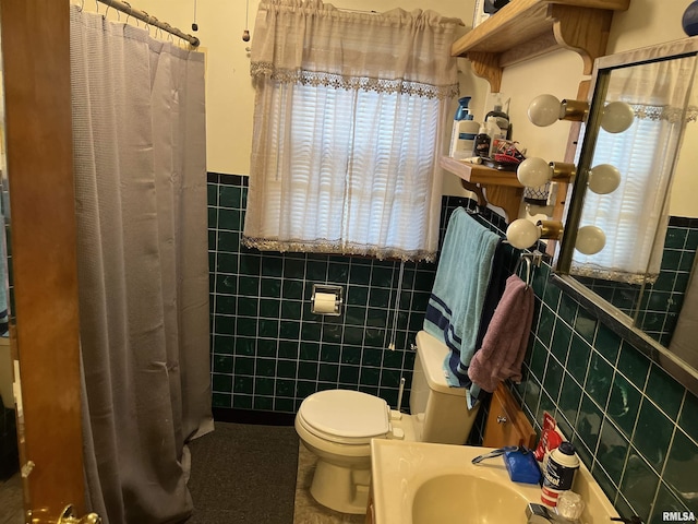 bathroom with a shower with curtain, toilet, sink, and tile walls