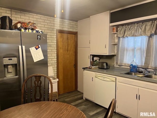 kitchen with sink, white dishwasher, white cabinets, dark hardwood / wood-style flooring, and stainless steel fridge with ice dispenser