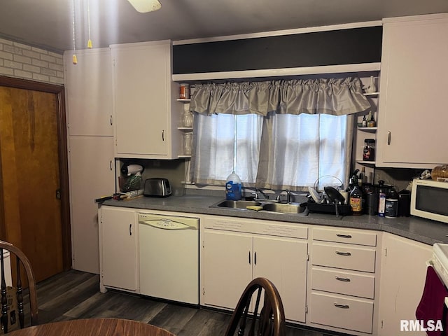 kitchen with sink, white appliances, and white cabinets