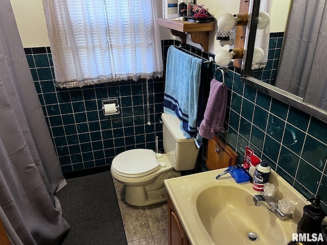 bathroom with tile walls, tile patterned floors, and toilet