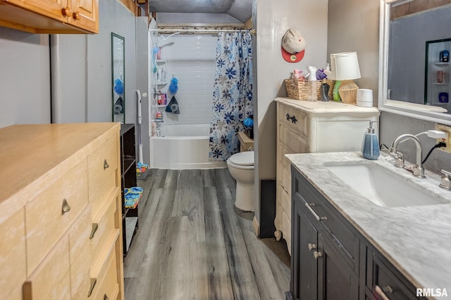 full bathroom with hardwood / wood-style flooring, vanity, shower / bath combination with curtain, and toilet