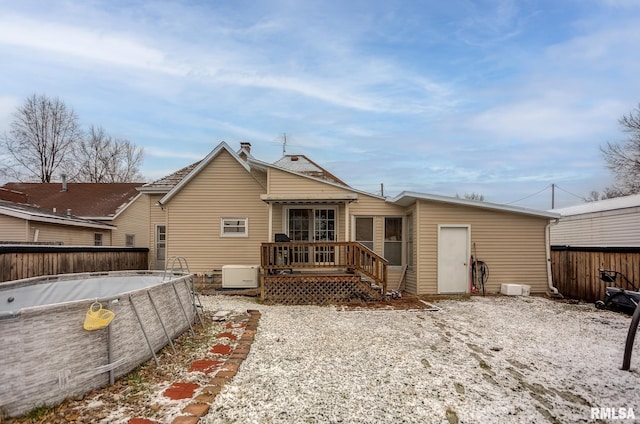 back of property featuring a swimming pool side deck