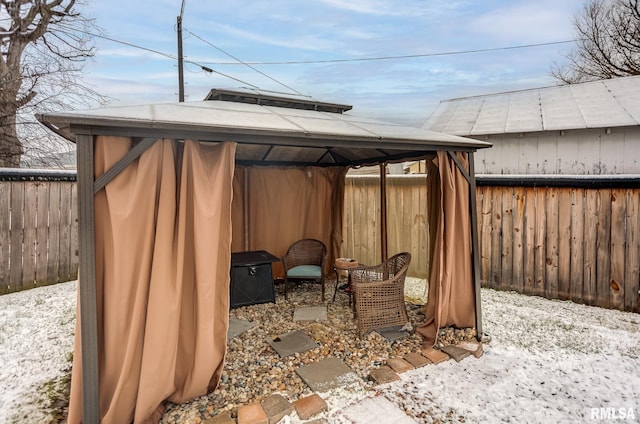 snow covered patio with a gazebo