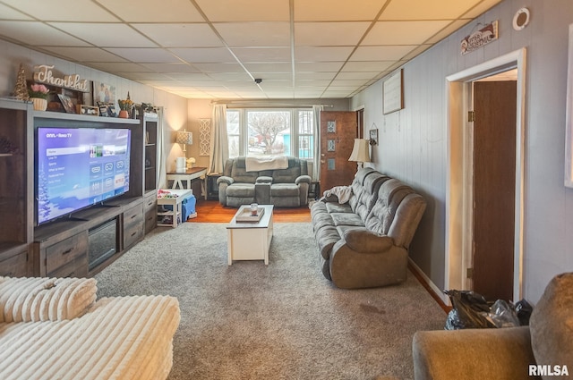 carpeted living room with a paneled ceiling