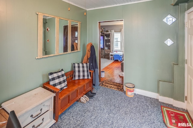 interior space with crown molding and carpet