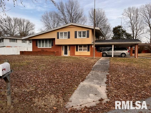 tri-level home featuring a carport