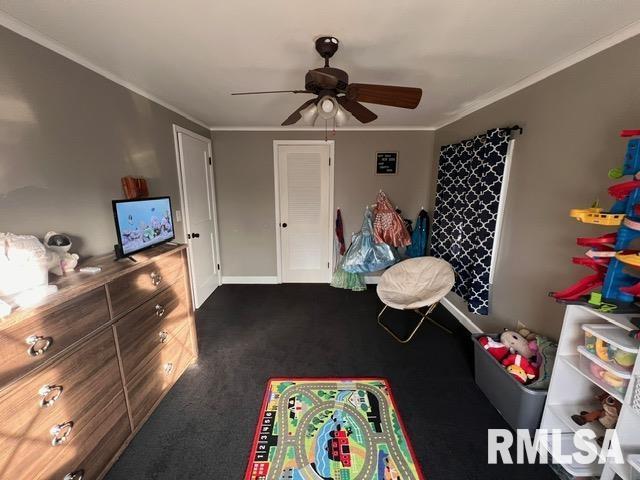 recreation room with ceiling fan and ornamental molding