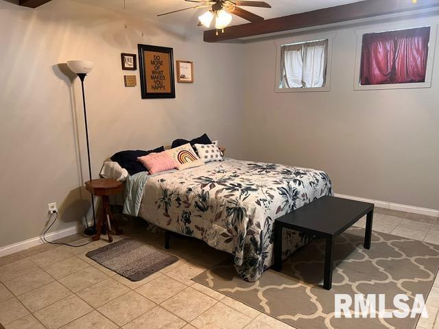 bedroom with ceiling fan and light tile patterned flooring