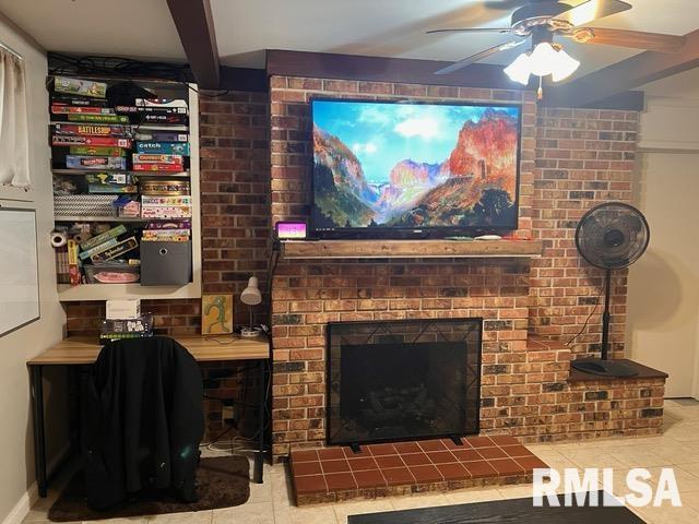 tiled living room featuring ceiling fan, beam ceiling, and a brick fireplace