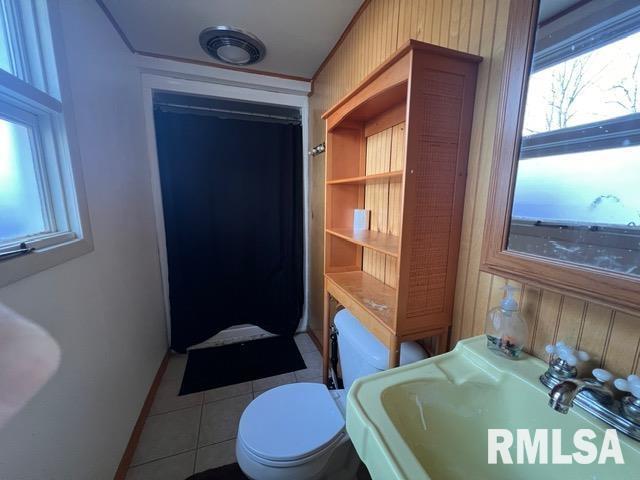 bathroom with sink, tile patterned floors, and toilet