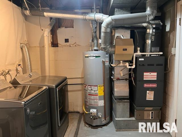 utilities with gas water heater, heating unit, and independent washer and dryer