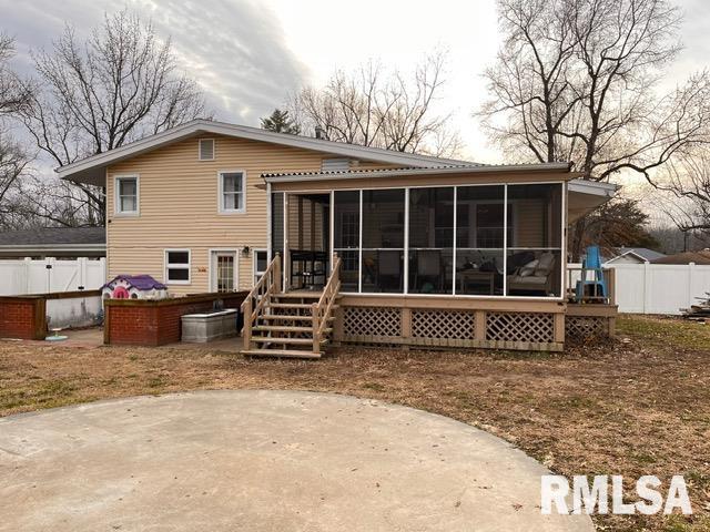 rear view of property featuring a sunroom