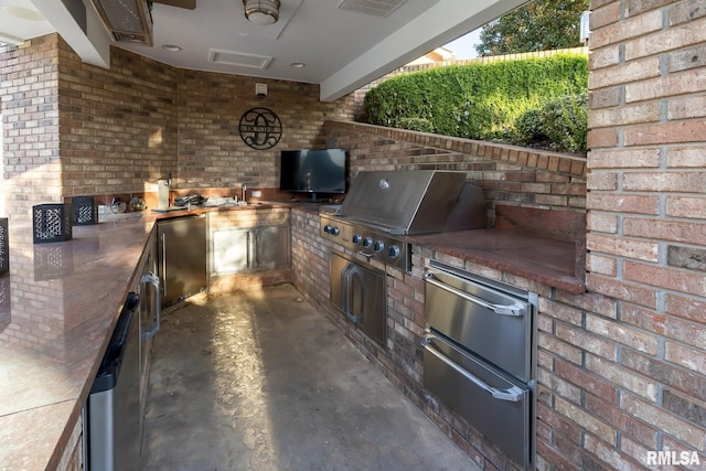view of patio featuring area for grilling and exterior kitchen