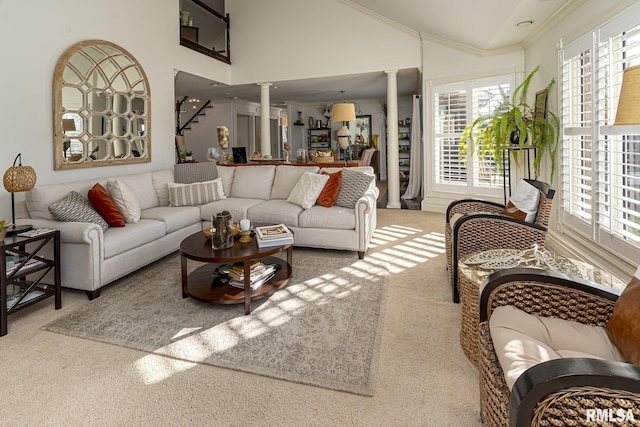 living room with ornamental molding, a healthy amount of sunlight, and ornate columns