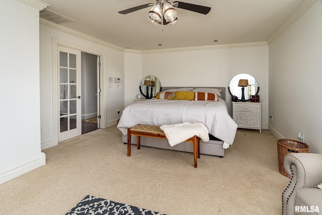 carpeted bedroom with ornamental molding and ceiling fan