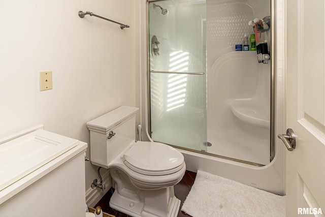 bathroom with vanity, a shower with shower door, and toilet