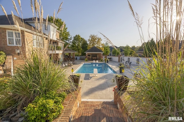 view of swimming pool featuring a gazebo and a patio