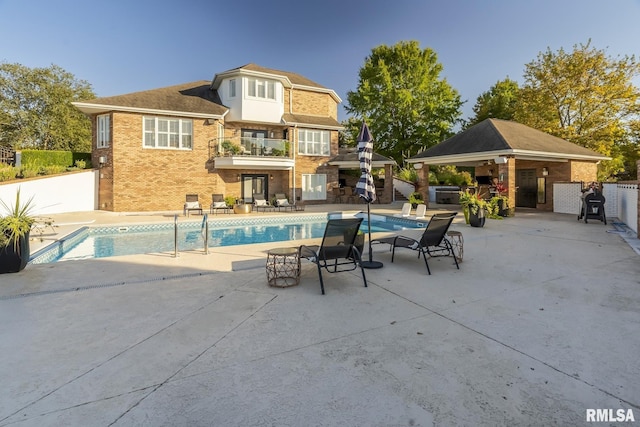 view of swimming pool featuring a gazebo, an outdoor bar, and a patio area