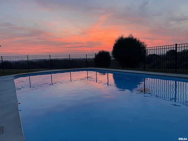 pool at dusk with fence
