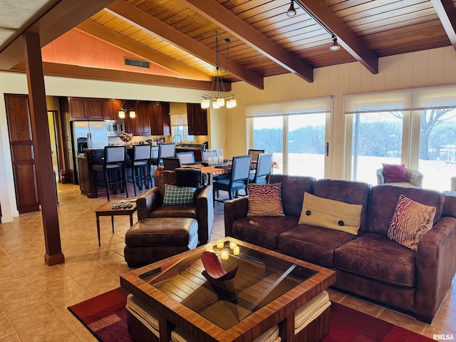 living area featuring lofted ceiling with beams, light tile patterned floors, wooden ceiling, visible vents, and an inviting chandelier