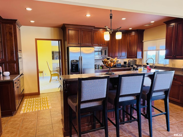 kitchen with appliances with stainless steel finishes, dark countertops, and recessed lighting