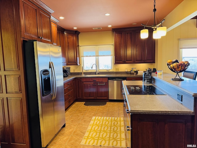 kitchen with appliances with stainless steel finishes, visible vents, plenty of natural light, and a sink