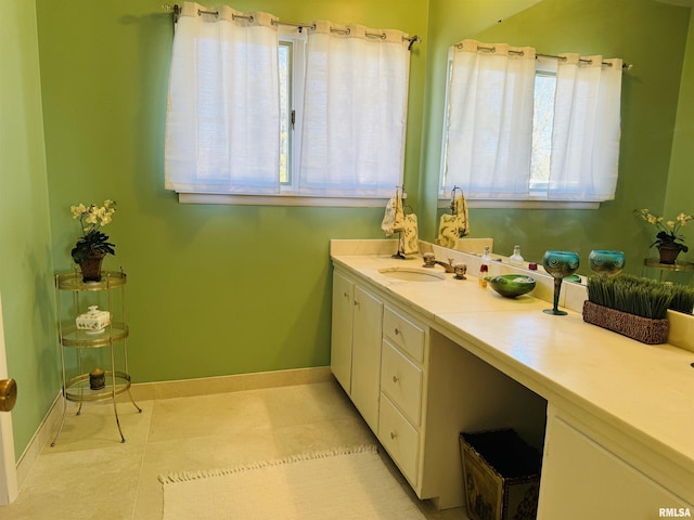 bathroom with baseboards and vanity