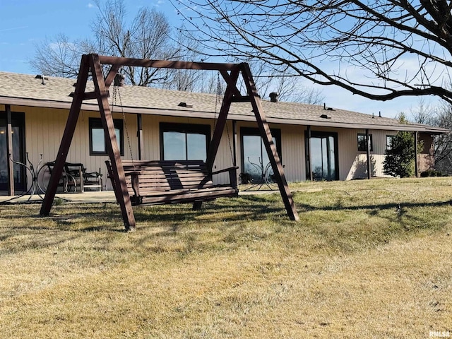 rear view of house with a lawn