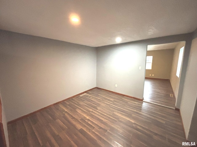 spare room featuring dark hardwood / wood-style flooring