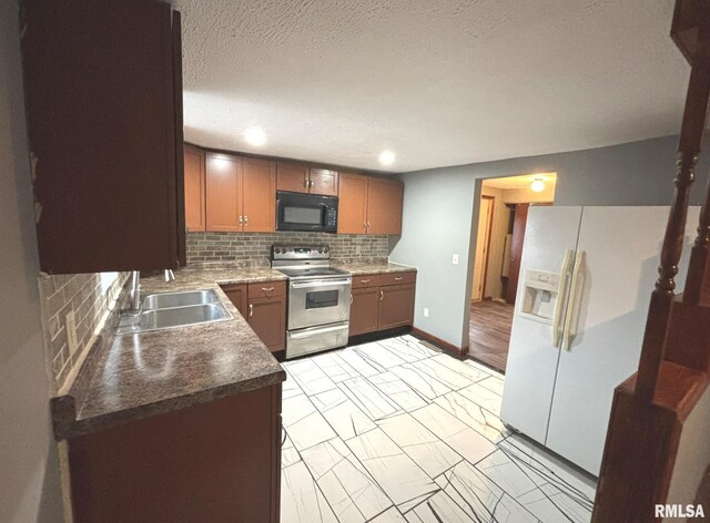 kitchen featuring tasteful backsplash, sink, white fridge with ice dispenser, electric range, and a textured ceiling