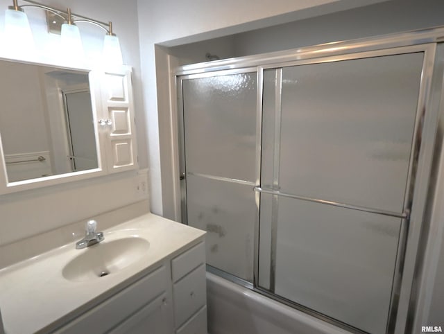 bathroom featuring enclosed tub / shower combo and vanity