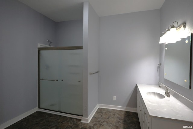 bathroom featuring vanity and a shower with shower door