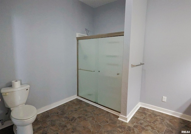 bathroom with an enclosed shower and toilet