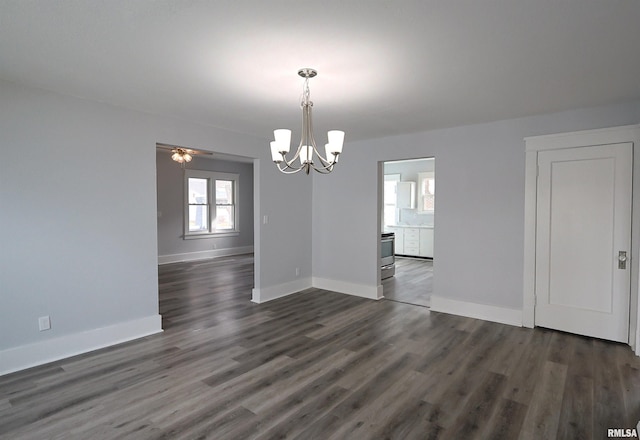 unfurnished dining area with dark hardwood / wood-style flooring and ceiling fan with notable chandelier
