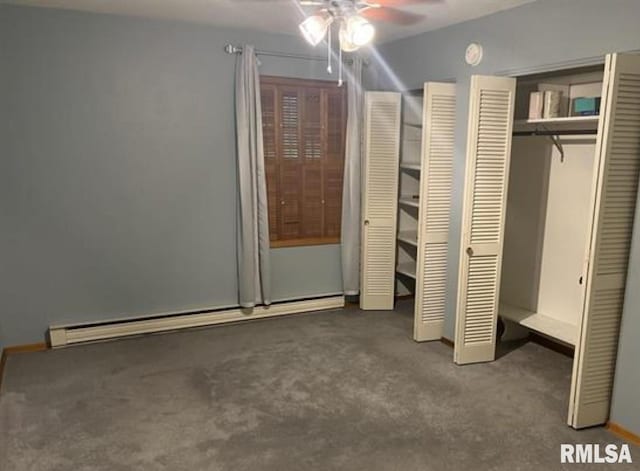 unfurnished bedroom featuring ceiling fan, dark carpet, a baseboard radiator, and multiple closets