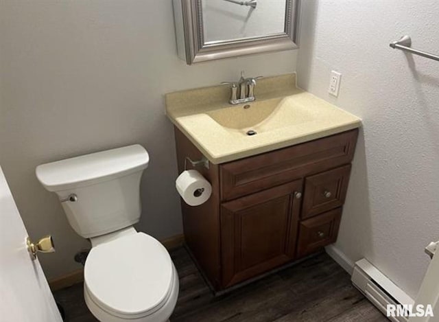 bathroom featuring a baseboard radiator, vanity, toilet, and wood-type flooring