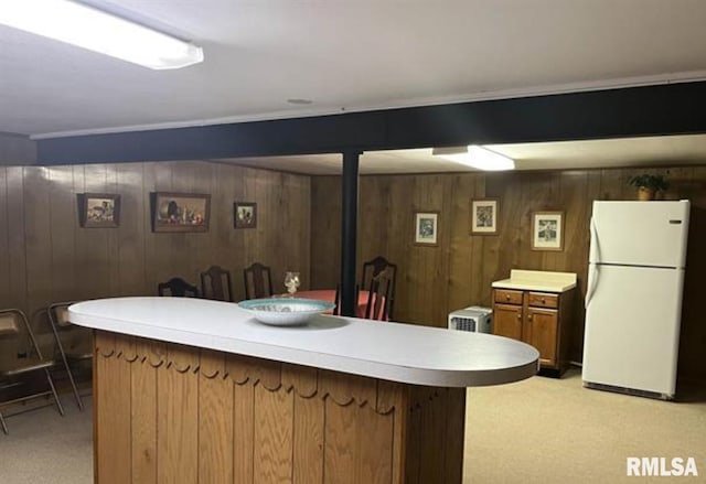 kitchen with light carpet and white refrigerator