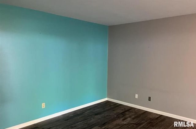 unfurnished room with dark wood-type flooring