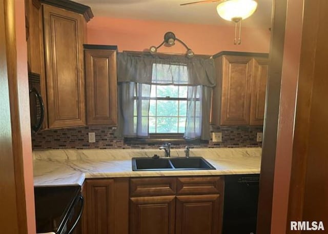 kitchen with ceiling fan, sink, decorative backsplash, and black appliances