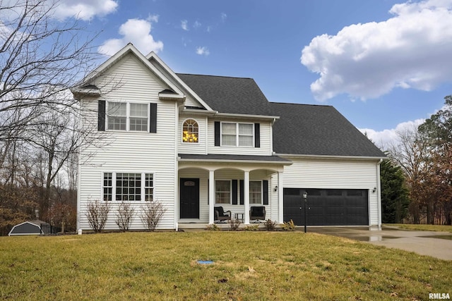 view of front of property with a garage, a front lawn, and covered porch