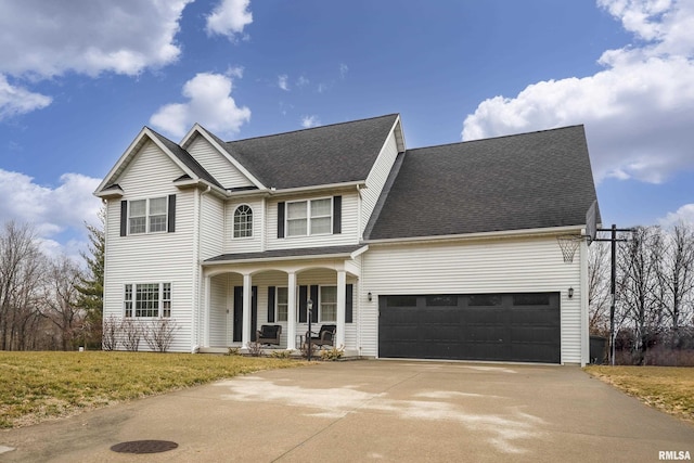 view of front facade featuring a garage, a front yard, and covered porch