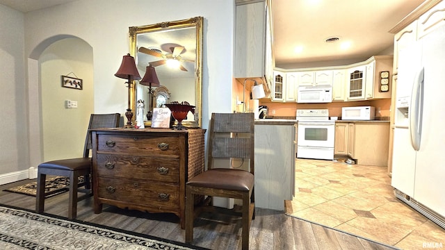 kitchen featuring white appliances and light hardwood / wood-style flooring