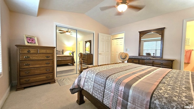 carpeted bedroom with vaulted ceiling, ceiling fan, and a closet