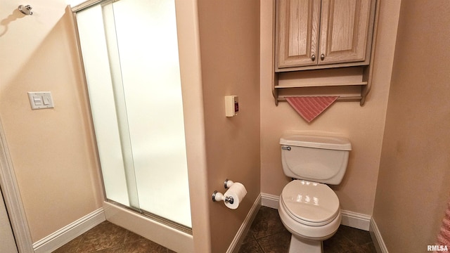 bathroom with tile patterned flooring and toilet