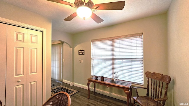 entryway with a textured ceiling, dark wood-type flooring, and ceiling fan