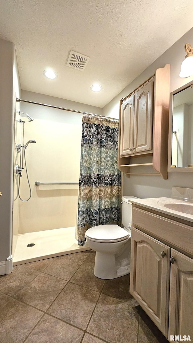 bathroom with vanity, a shower with curtain, a textured ceiling, and toilet