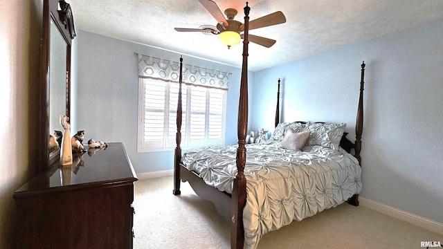 carpeted bedroom featuring ceiling fan and a textured ceiling