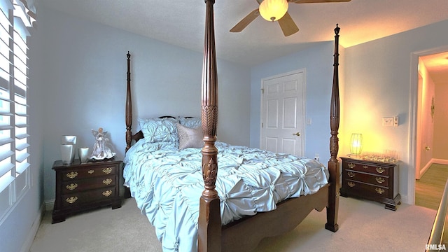 bedroom featuring ceiling fan and light carpet