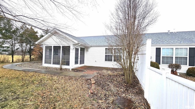 rear view of property featuring a sunroom