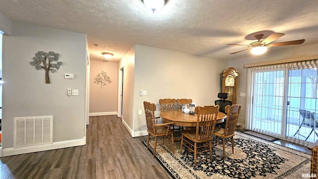 dining space featuring ceiling fan, dark hardwood / wood-style flooring, and a textured ceiling